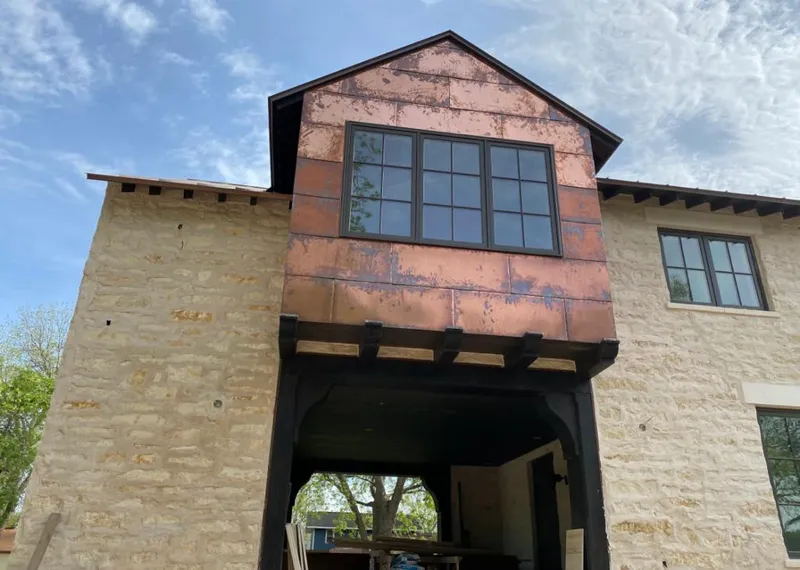 Copper metal panel facade on a stone building for Skylight Installation in Leisure World